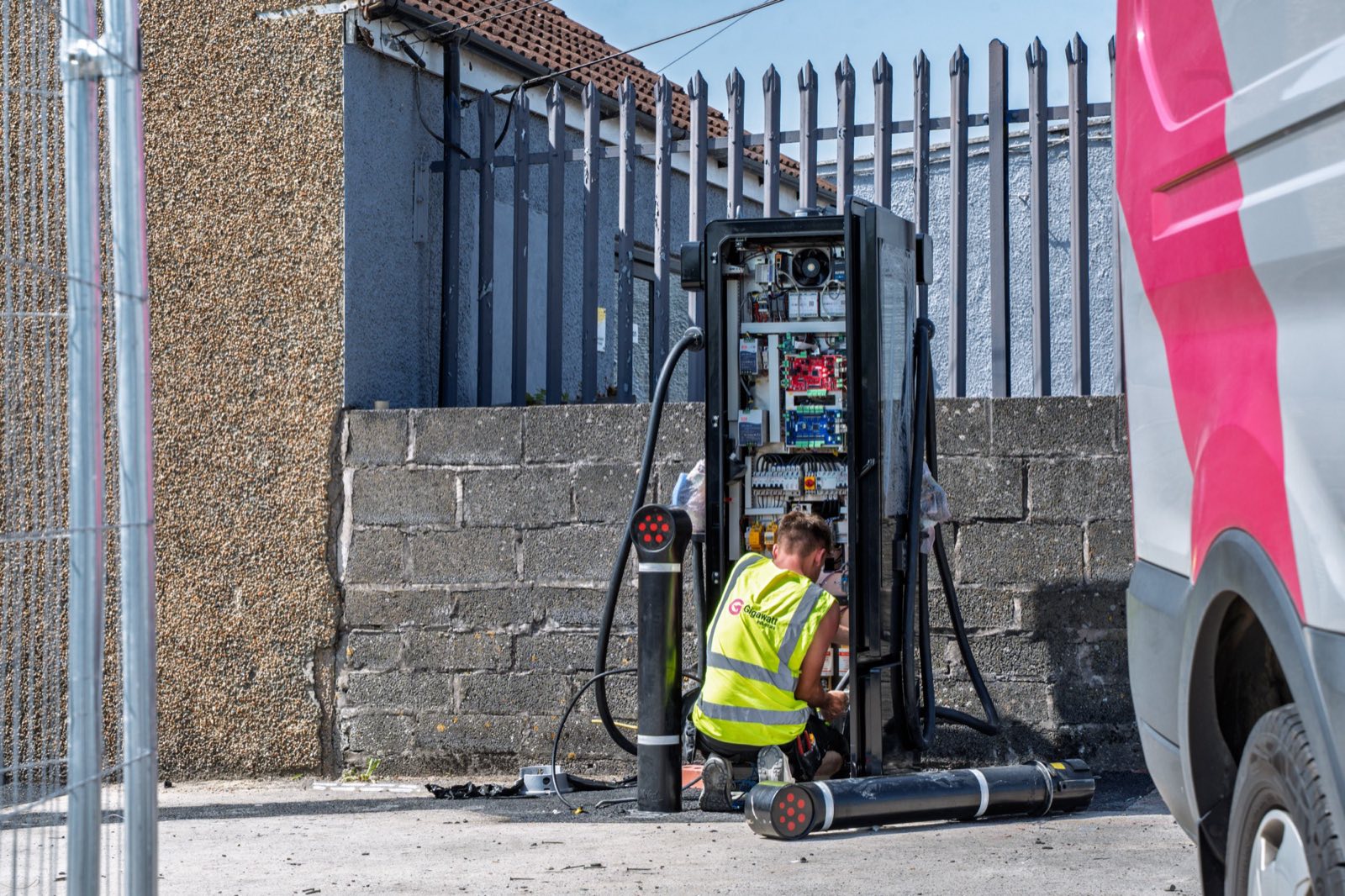 Gigawatt engineer terminating inside an open charger cabinet