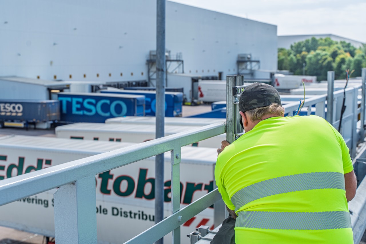 Charger install overlooking Tesco and Eddie Stobart trailers at a distribution centre