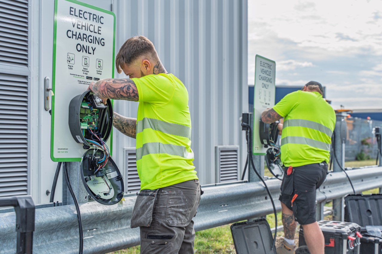 Electricians wiring Solo 22kW chargers at a Tesco distribution centre
